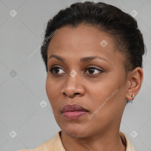 Joyful black young-adult female with short  brown hair and brown eyes