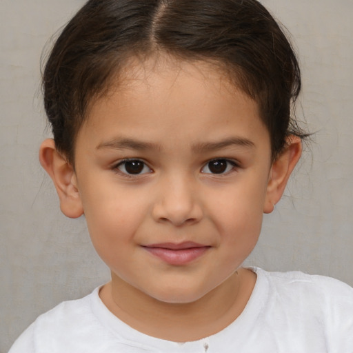 Joyful white child female with short  brown hair and brown eyes