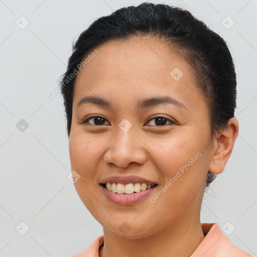 Joyful latino young-adult female with short  brown hair and brown eyes