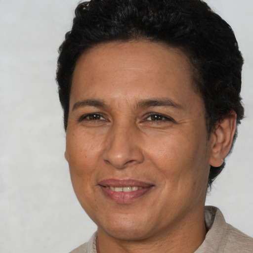 Joyful latino adult female with short  brown hair and brown eyes