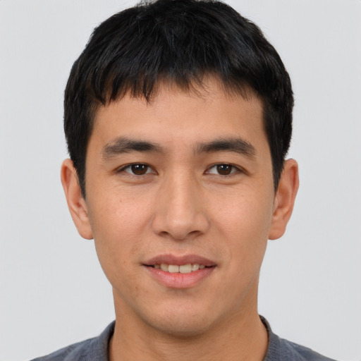 Joyful asian young-adult male with short  black hair and brown eyes