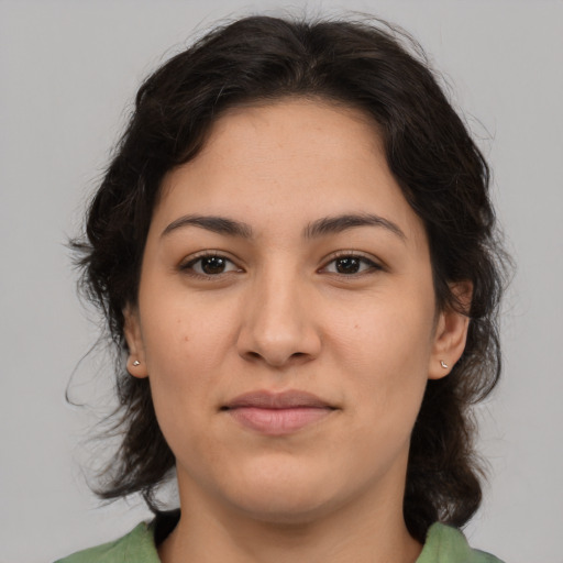 Joyful latino young-adult female with medium  brown hair and brown eyes