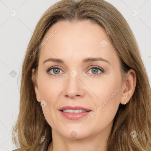 Joyful white adult female with long  brown hair and grey eyes