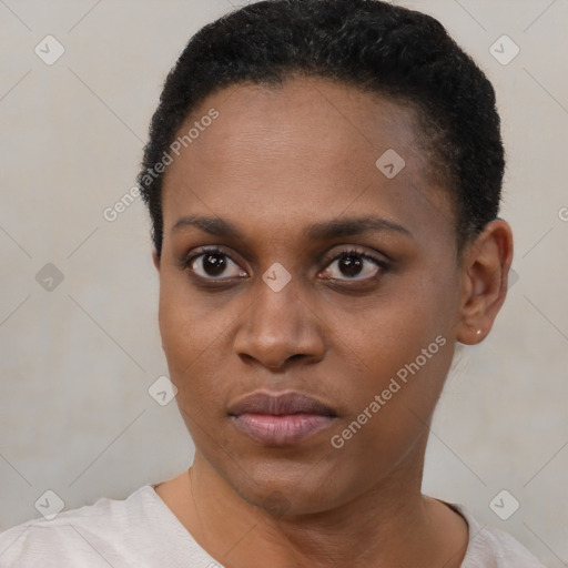 Joyful black young-adult female with short  brown hair and brown eyes