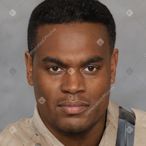 Joyful black young-adult male with short  brown hair and brown eyes