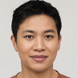 Joyful asian young-adult male with short  black hair and brown eyes