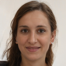 Joyful white young-adult female with long  brown hair and grey eyes