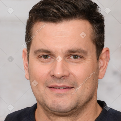 Joyful white adult male with short  brown hair and brown eyes