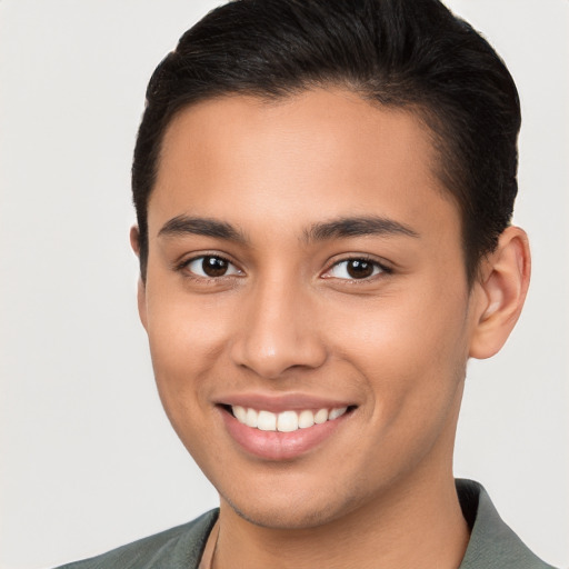 Joyful latino young-adult male with short  brown hair and brown eyes