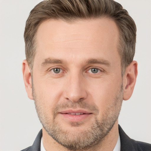 Joyful white adult male with short  brown hair and brown eyes