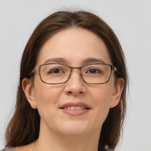 Joyful white adult female with medium  brown hair and grey eyes