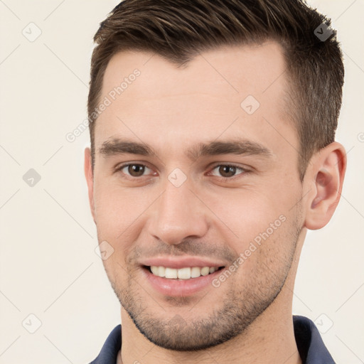 Joyful white young-adult male with short  brown hair and brown eyes