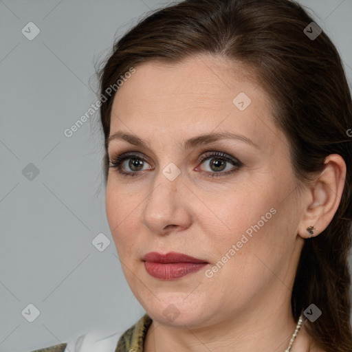 Joyful white adult female with medium  brown hair and brown eyes