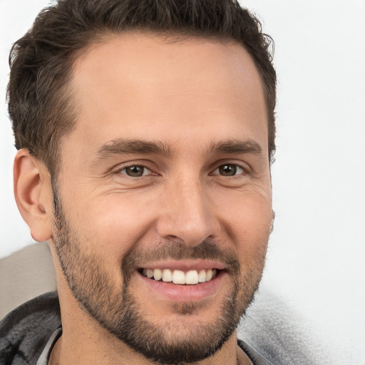 Joyful white young-adult male with short  brown hair and brown eyes