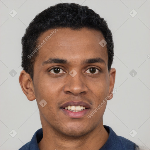 Joyful black young-adult male with short  black hair and brown eyes