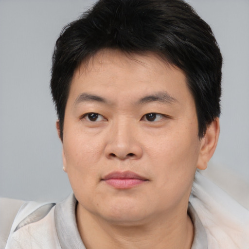 Neutral asian young-adult male with short  brown hair and brown eyes