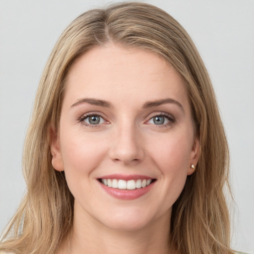 Joyful white young-adult female with long  brown hair and green eyes