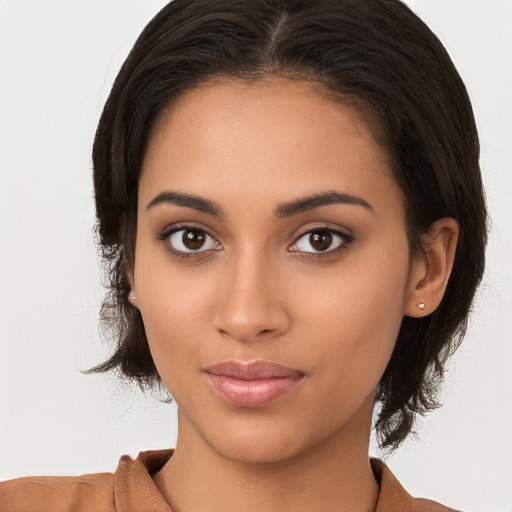 Joyful latino young-adult female with long  brown hair and brown eyes