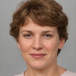 Joyful white adult female with medium  brown hair and grey eyes