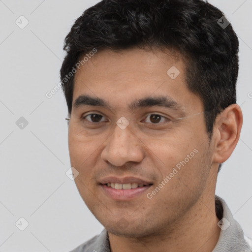 Joyful latino young-adult male with short  black hair and brown eyes