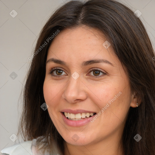 Joyful white young-adult female with long  brown hair and brown eyes