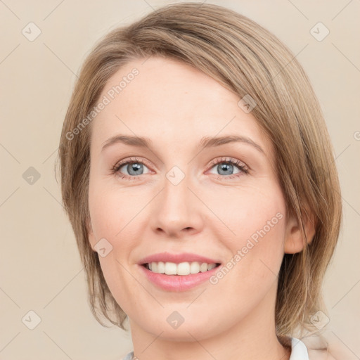 Joyful white young-adult female with medium  brown hair and green eyes