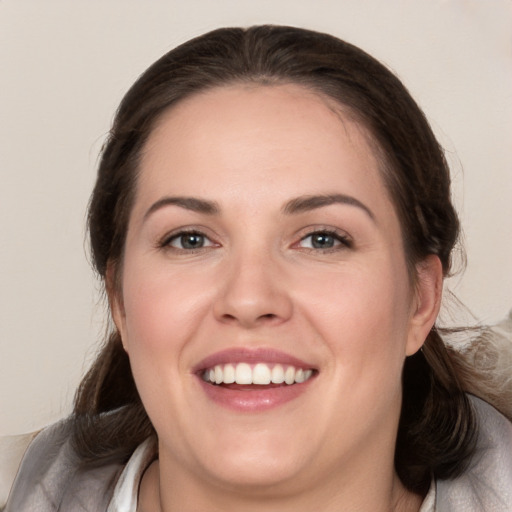 Joyful white young-adult female with medium  brown hair and brown eyes