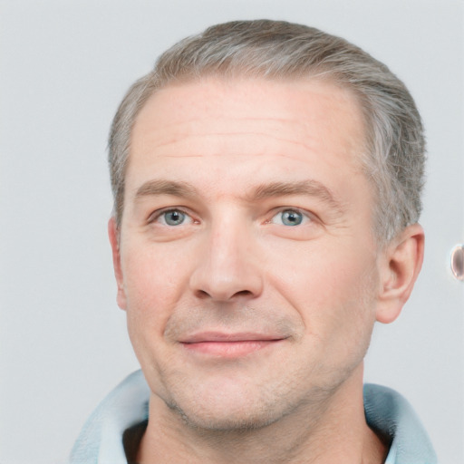 Joyful white adult male with short  brown hair and grey eyes