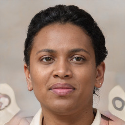 Joyful black young-adult female with short  brown hair and brown eyes