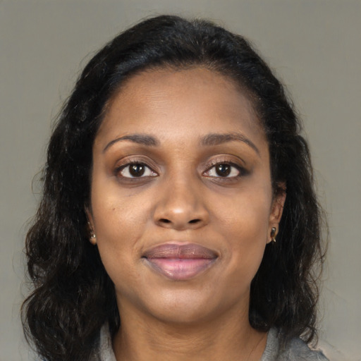 Joyful black young-adult female with medium  brown hair and brown eyes