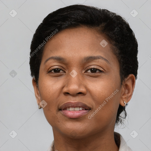 Joyful black adult female with short  brown hair and brown eyes