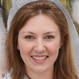 Joyful white adult female with long  brown hair and brown eyes