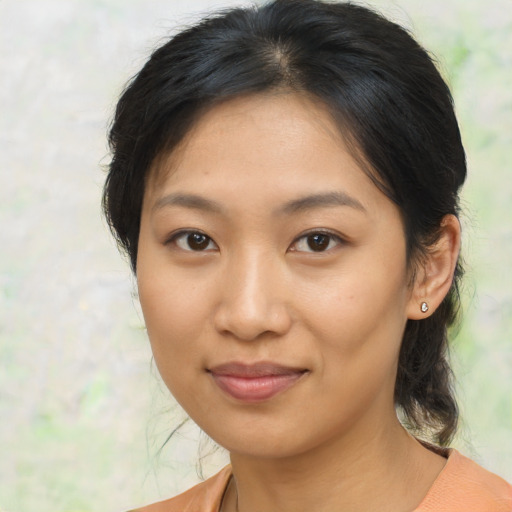 Joyful asian young-adult female with medium  brown hair and brown eyes
