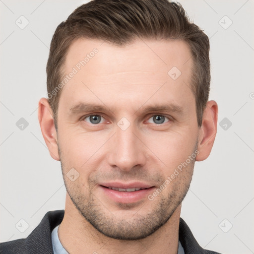 Joyful white young-adult male with short  brown hair and grey eyes