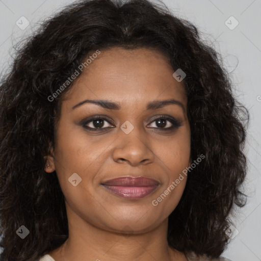 Joyful black young-adult female with long  brown hair and brown eyes