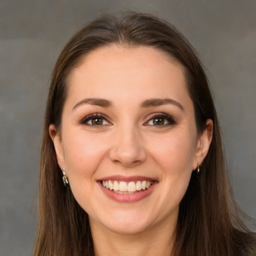 Joyful white young-adult female with long  brown hair and brown eyes