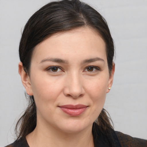 Joyful white young-adult female with medium  brown hair and brown eyes