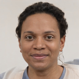 Joyful black adult female with short  brown hair and brown eyes