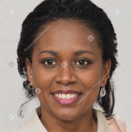 Joyful black adult female with medium  brown hair and brown eyes