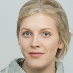 Joyful white young-adult female with medium  brown hair and blue eyes