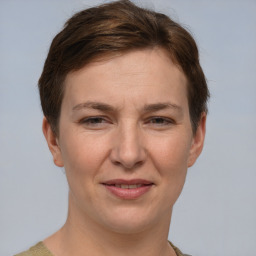 Joyful white young-adult female with short  brown hair and grey eyes