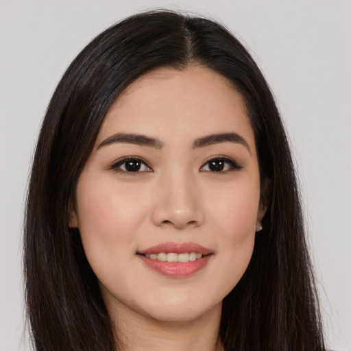 Joyful asian young-adult female with long  brown hair and brown eyes