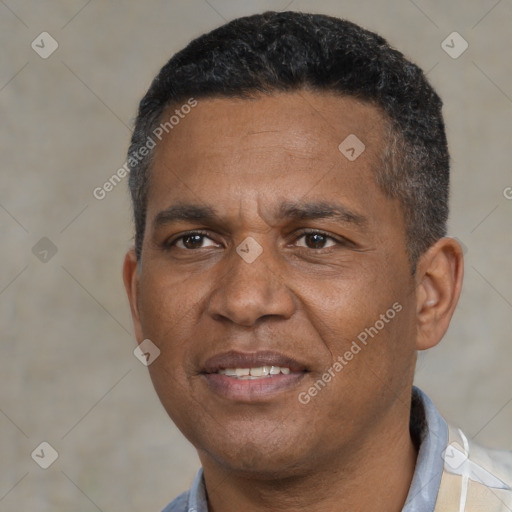 Joyful black adult male with short  black hair and brown eyes