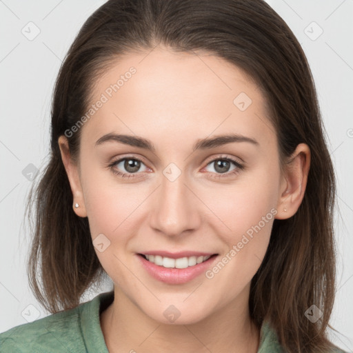 Joyful white young-adult female with long  brown hair and grey eyes