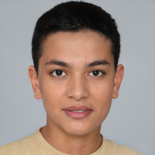 Joyful latino young-adult male with short  brown hair and brown eyes