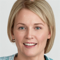 Joyful white young-adult female with medium  brown hair and blue eyes