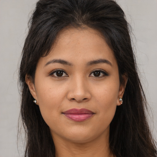 Joyful asian young-adult female with long  brown hair and brown eyes