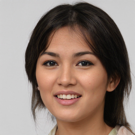 Joyful asian young-adult female with medium  brown hair and brown eyes