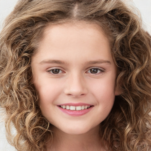 Joyful white child female with medium  brown hair and brown eyes