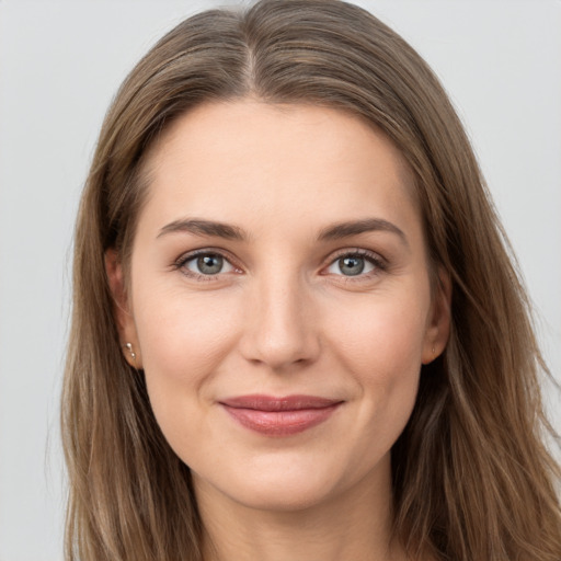 Joyful white young-adult female with long  brown hair and grey eyes